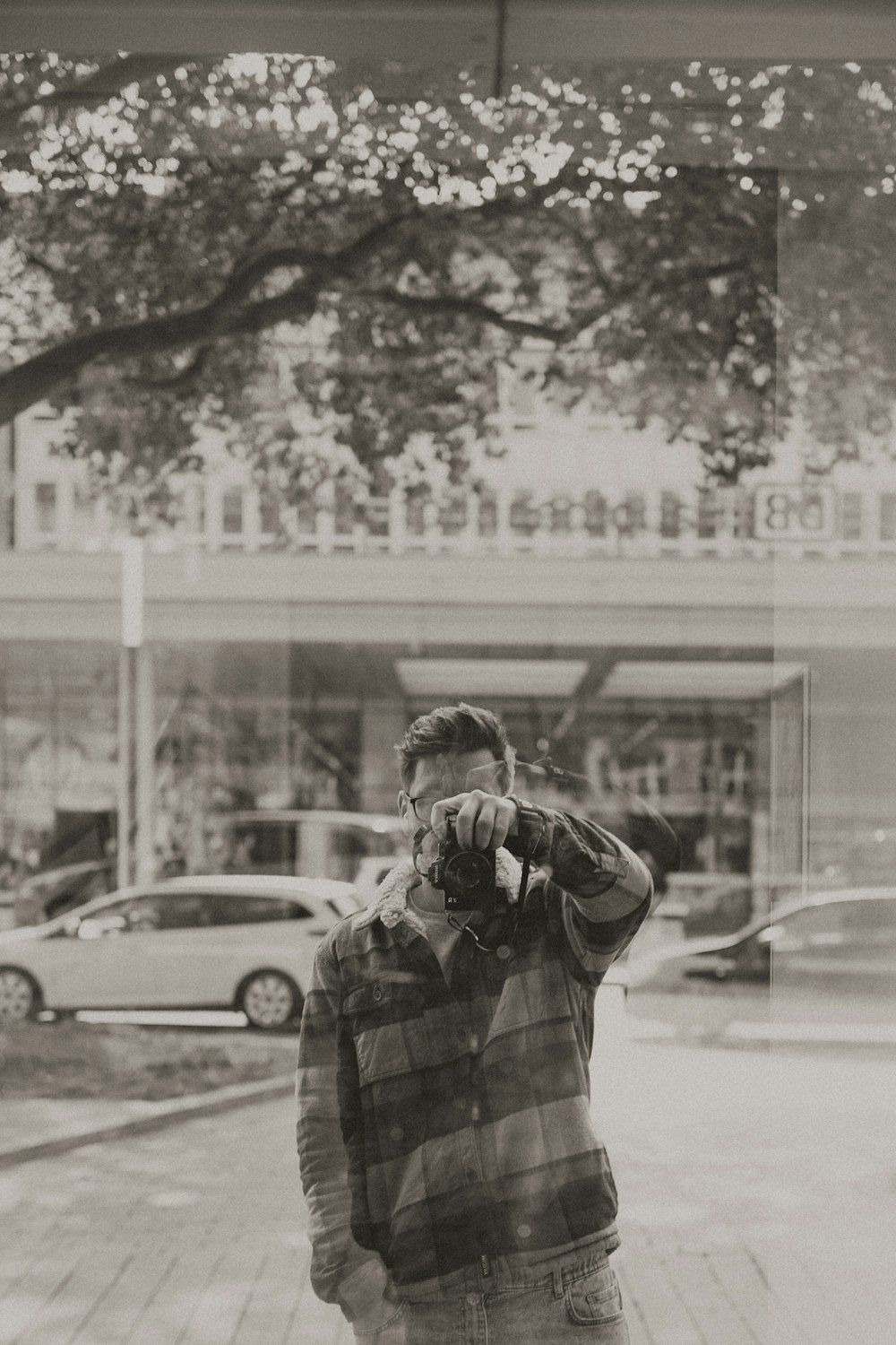 a man standing on a sidewalk talking on a cell phone