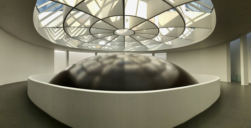 a large metal ball in a white room
