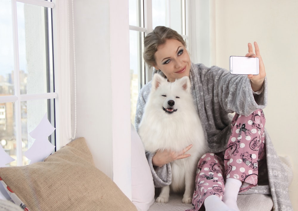 a woman taking a selfie with her dog