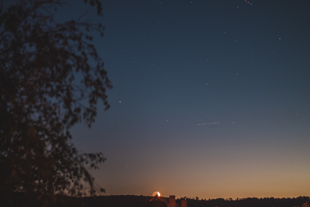 a night sky with a few stars in the distance