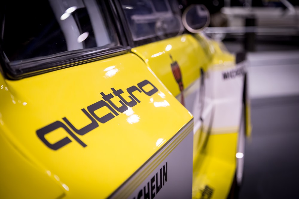 a close up of the front of a yellow car