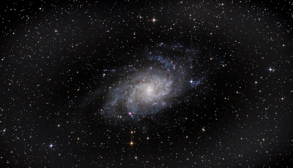 a spiral galaxy with stars in the background