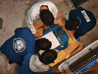 A group of people standing around a table