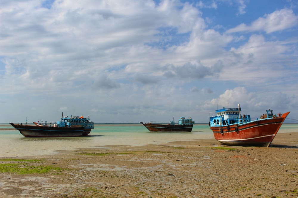 un groupe de bateaux assis au sommet d’une plage de sable