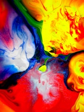 A vibrant abstract painting symbolizing creativity and transformation in a workspace.