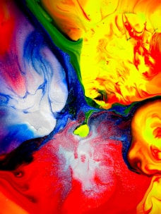 A vibrant abstract painting symbolizing creativity and transformation in a workspace.