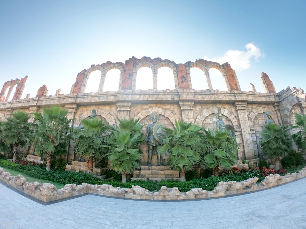 a large building with palm trees in front of it