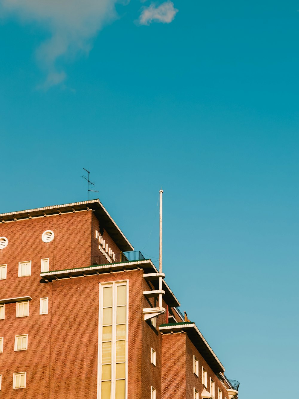 a tall brick building with a sky background