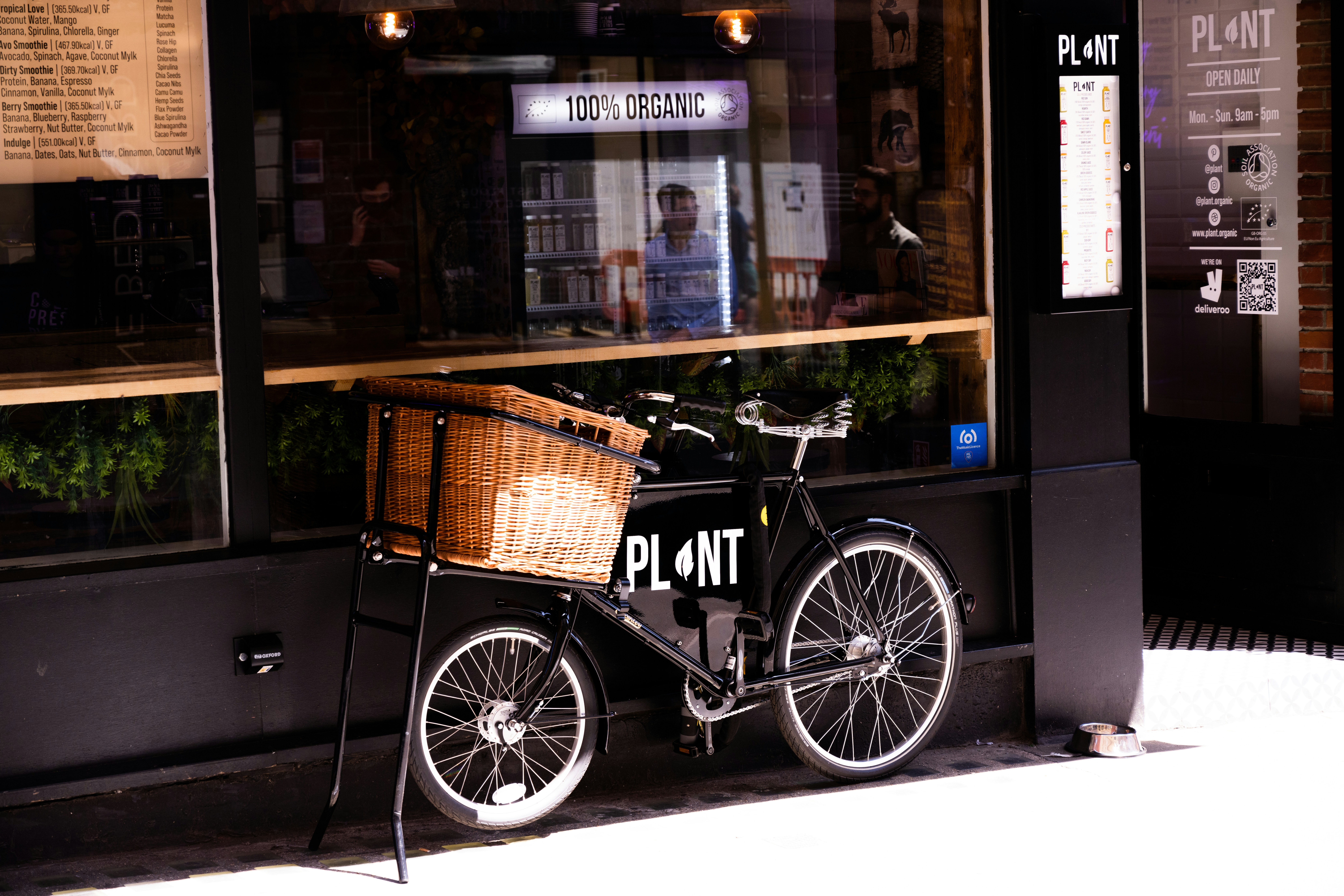 a bicycle parked in front of a restaurant, PLANT bike! 