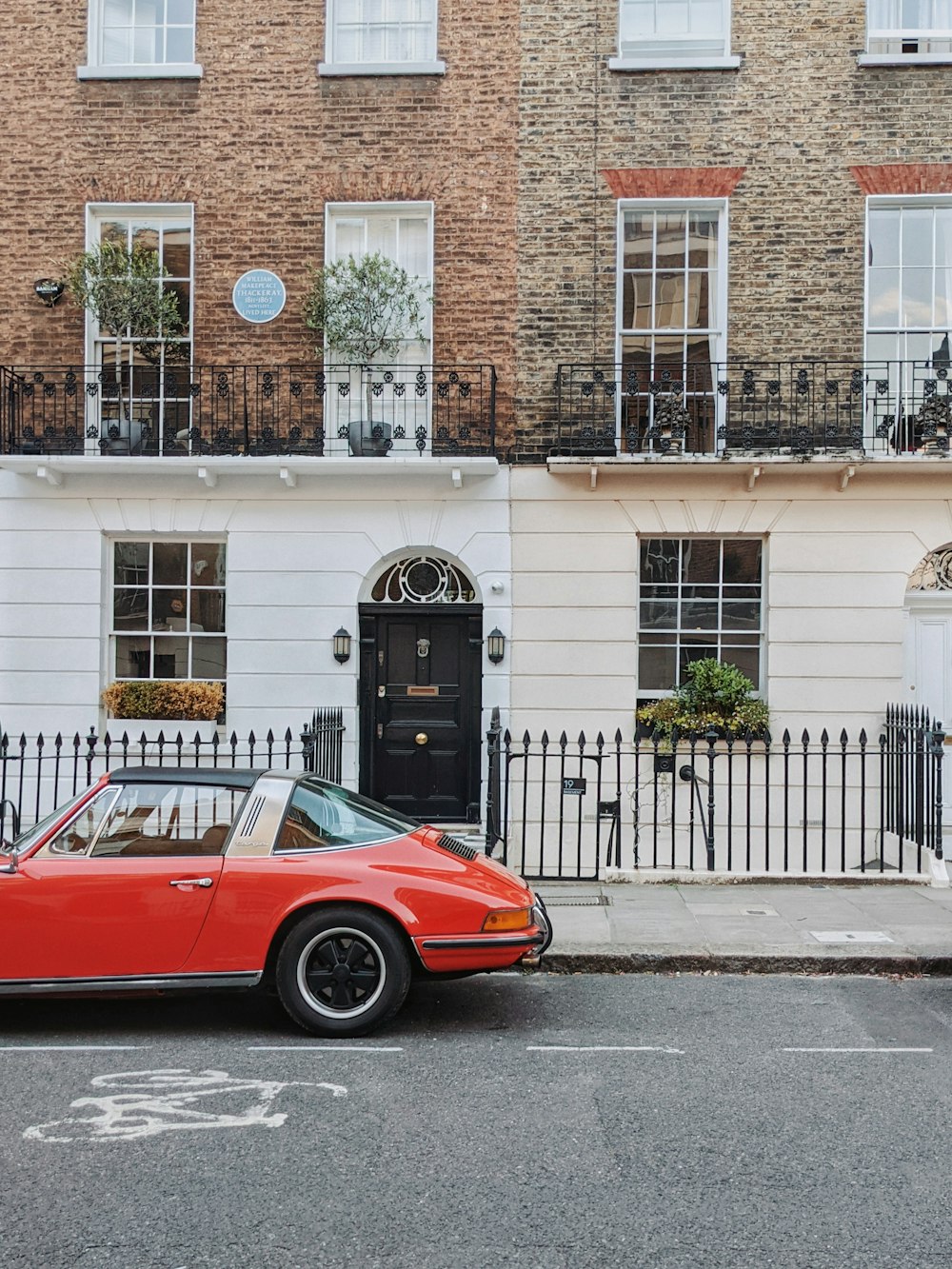 a red car parked on the side of a street