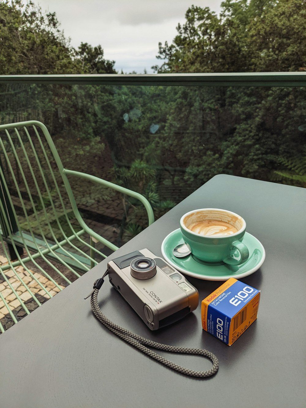 a camera and a cup of coffee on a table