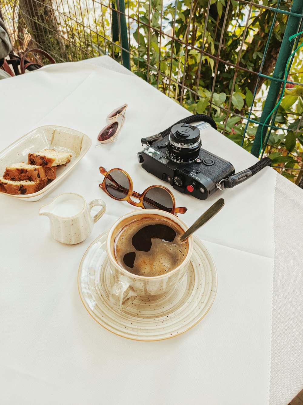 a cup of coffee sitting on top of a white table