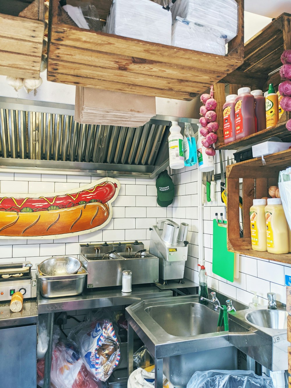 a kitchen with a hot dog on the wall