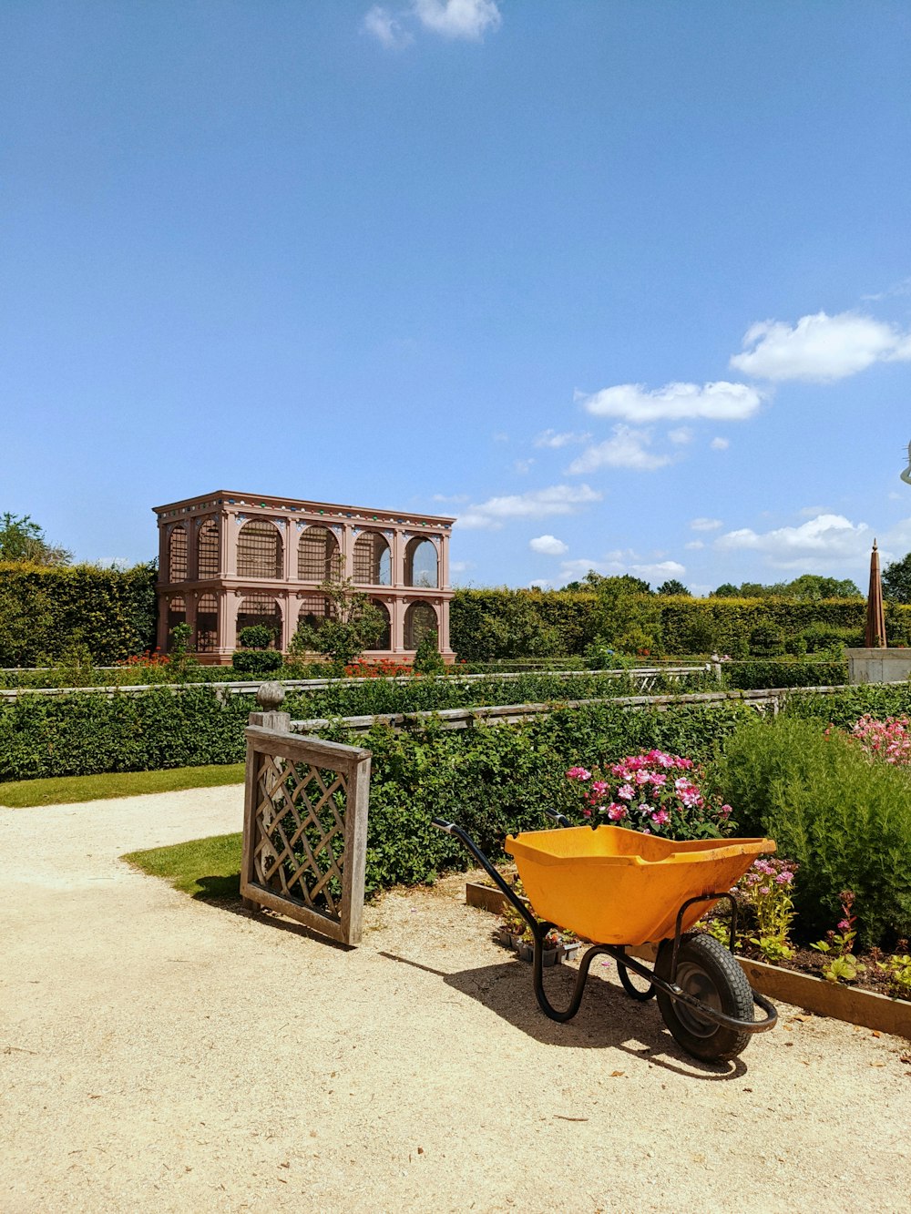 a wheelbarrow with a yellow wheel in front of a building