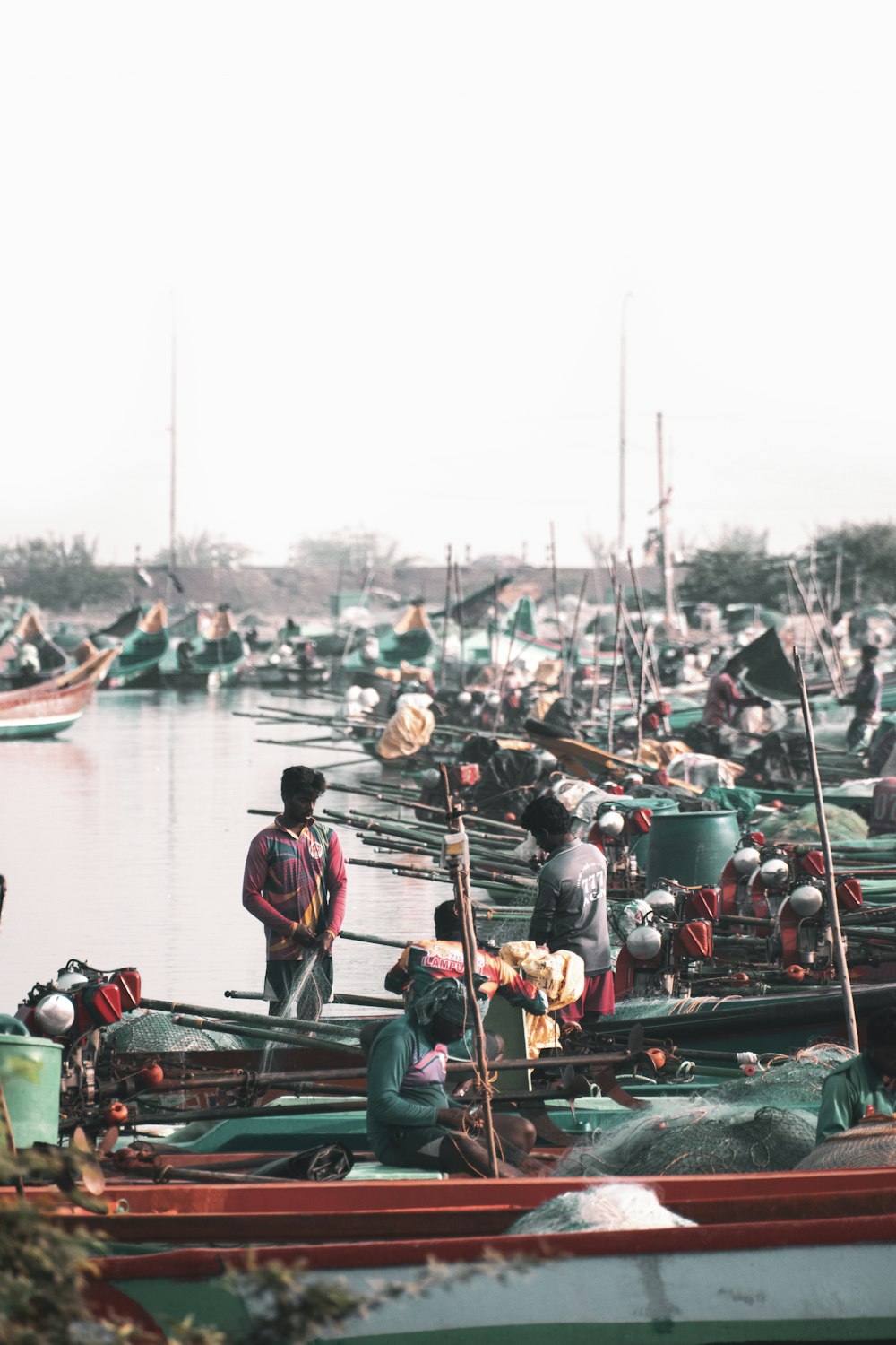 a group of people standing on top of small boats