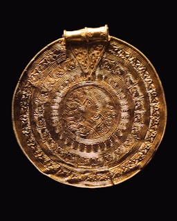 a gold plate with a design on it