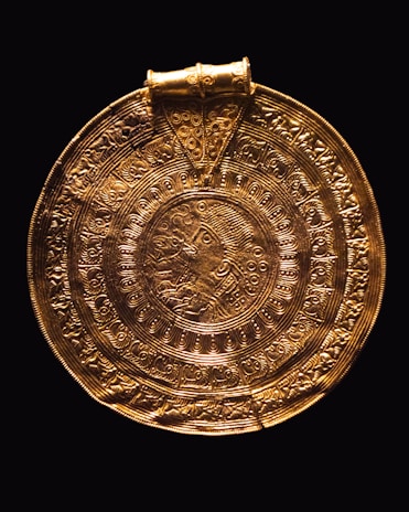 a gold plate with a design on it