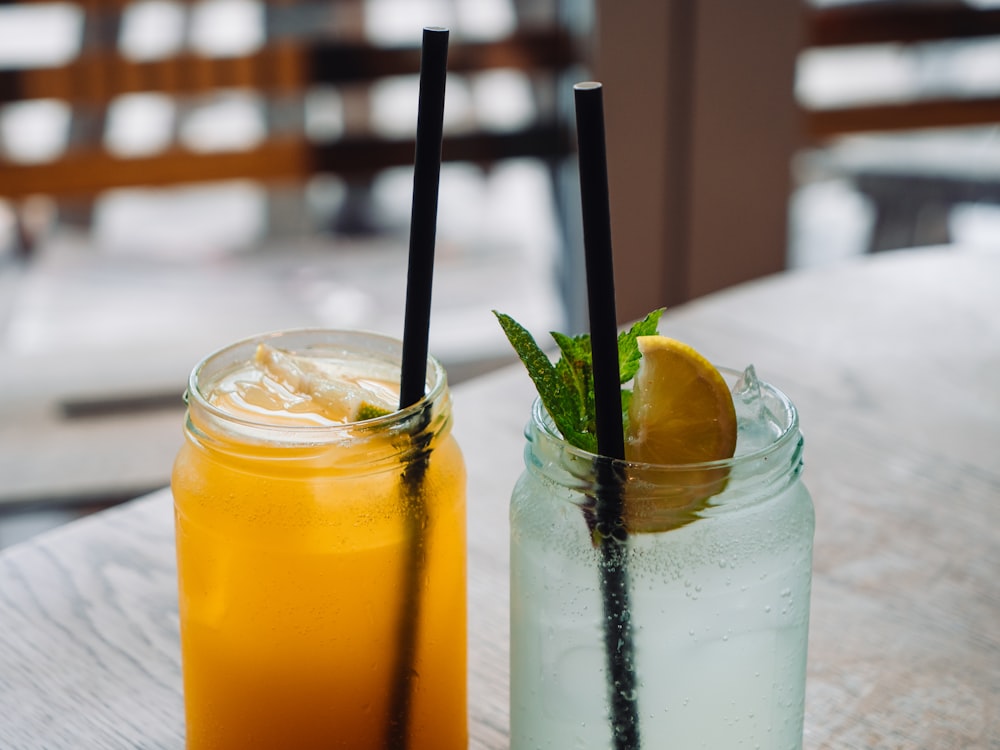 a couple of drinks sitting on top of a wooden table