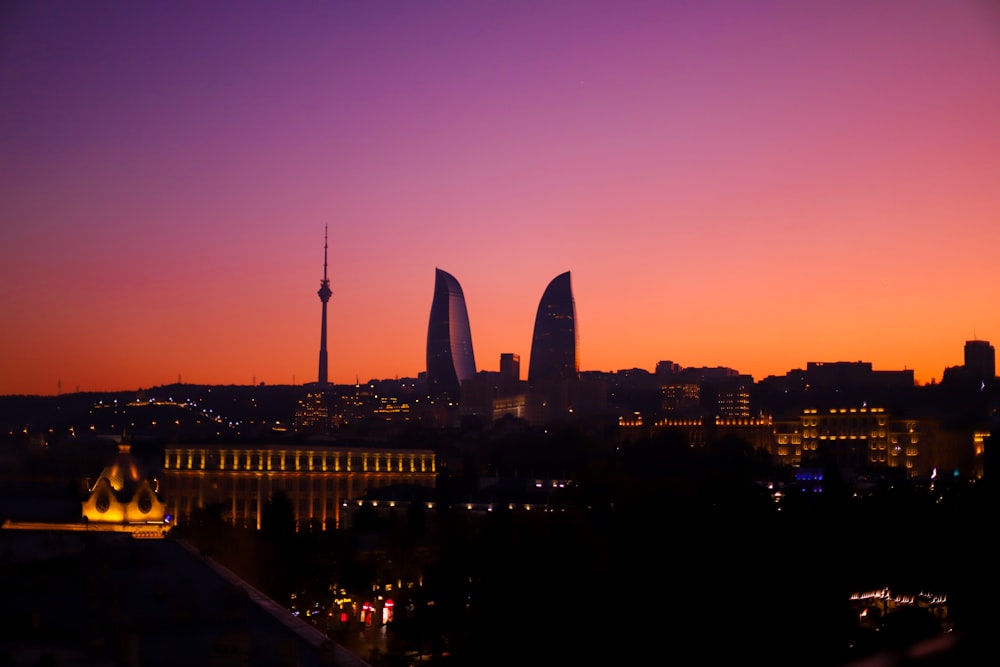 a sunset view of a city with tall buildings