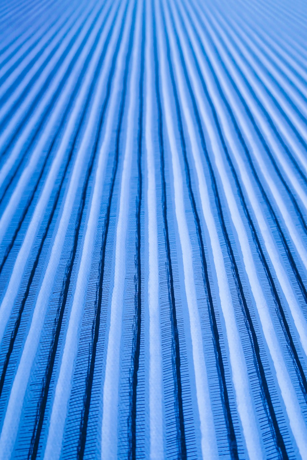 a close up of a blue and white striped surface