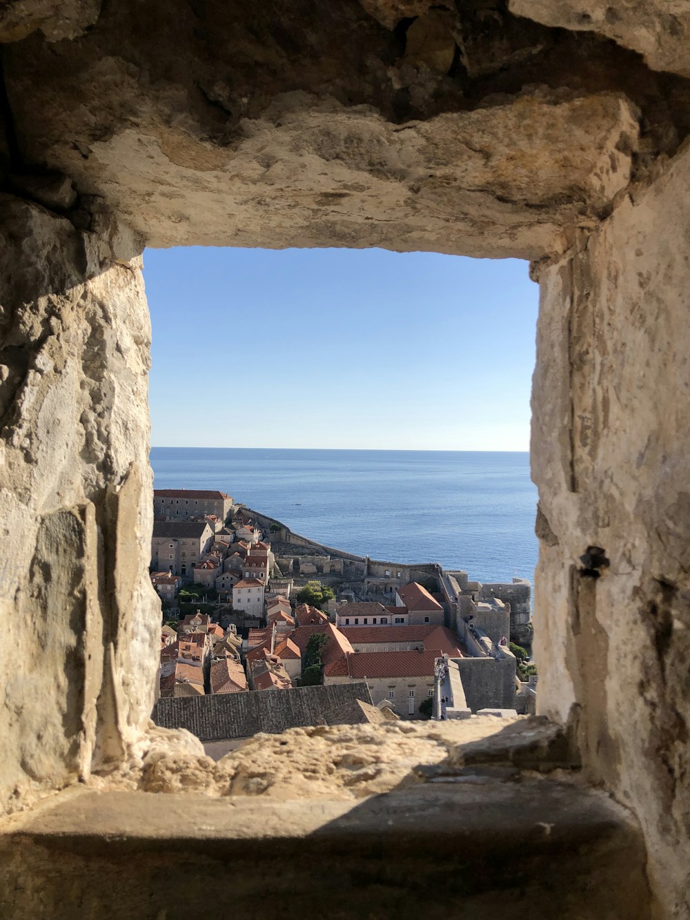 a view of a city through a stone window