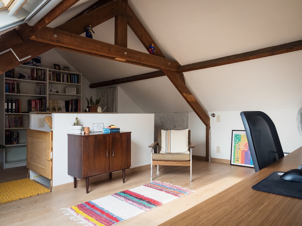 a living room with a chair and a book shelf