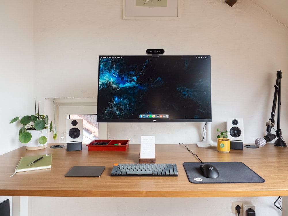 a computer monitor sitting on top of a wooden desk