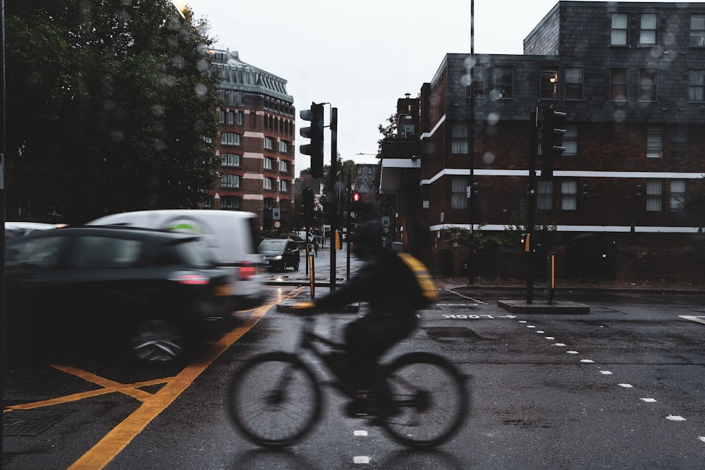 a person riding a bike on a city street