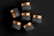 A beautifully arranged display of various cosmetic sample jars on a wooden table.