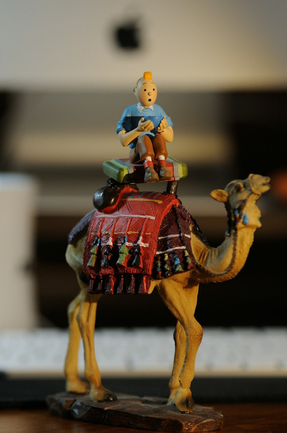 a figurine of a man sitting on top of a camel