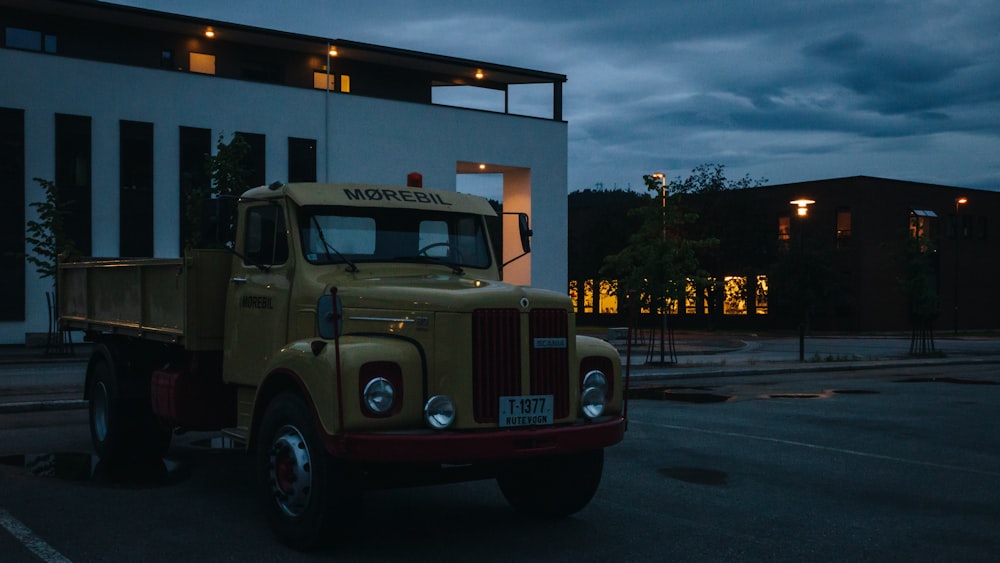 a yellow truck parked in front of a building