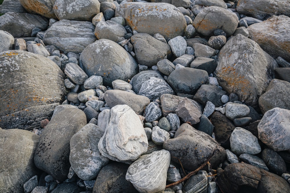 a pile of rocks sitting on top of a beach