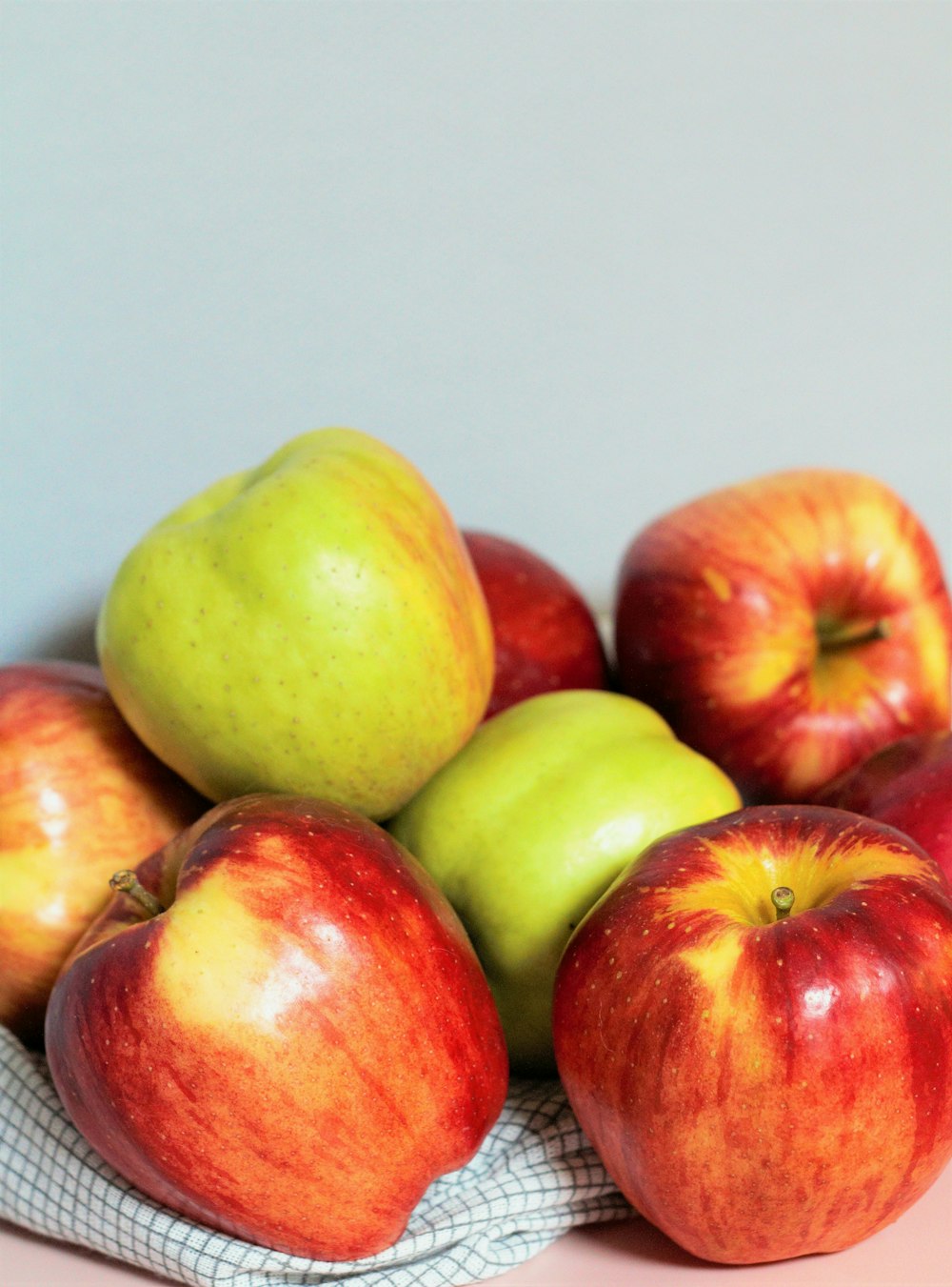 a pile of apples sitting on top of a table