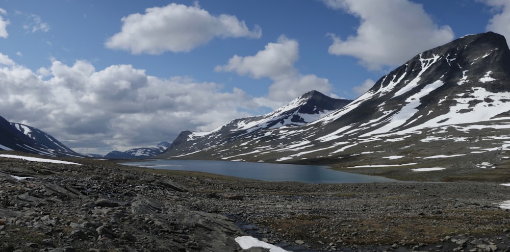 a mountain range with a body of water in the foreground