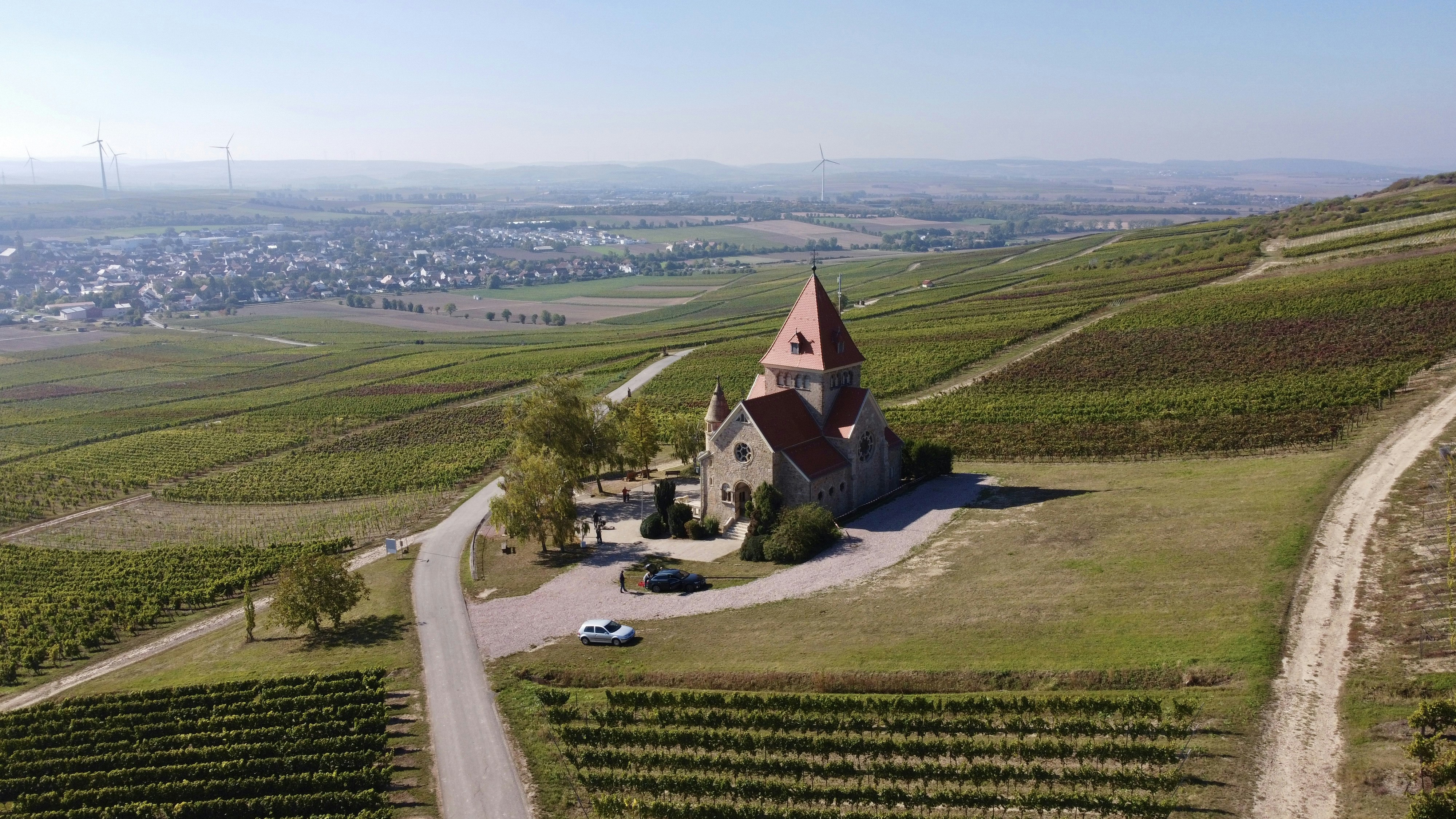 an aerial view of a church in a vineyard, 