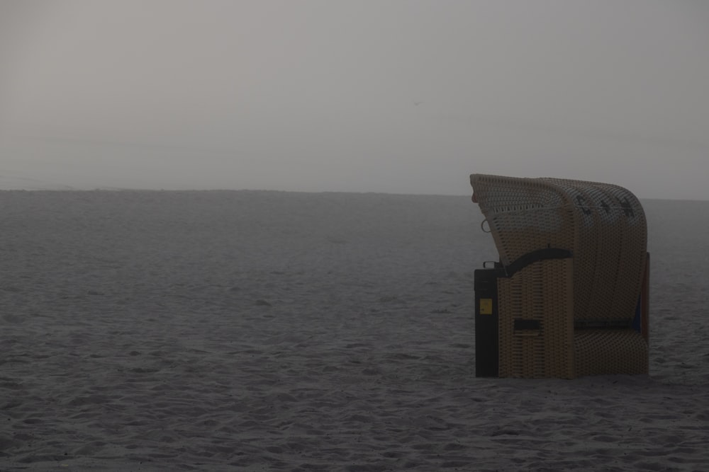 a chair sitting on top of a sandy beach