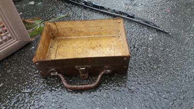 a wooden box sitting on top of a wet ground