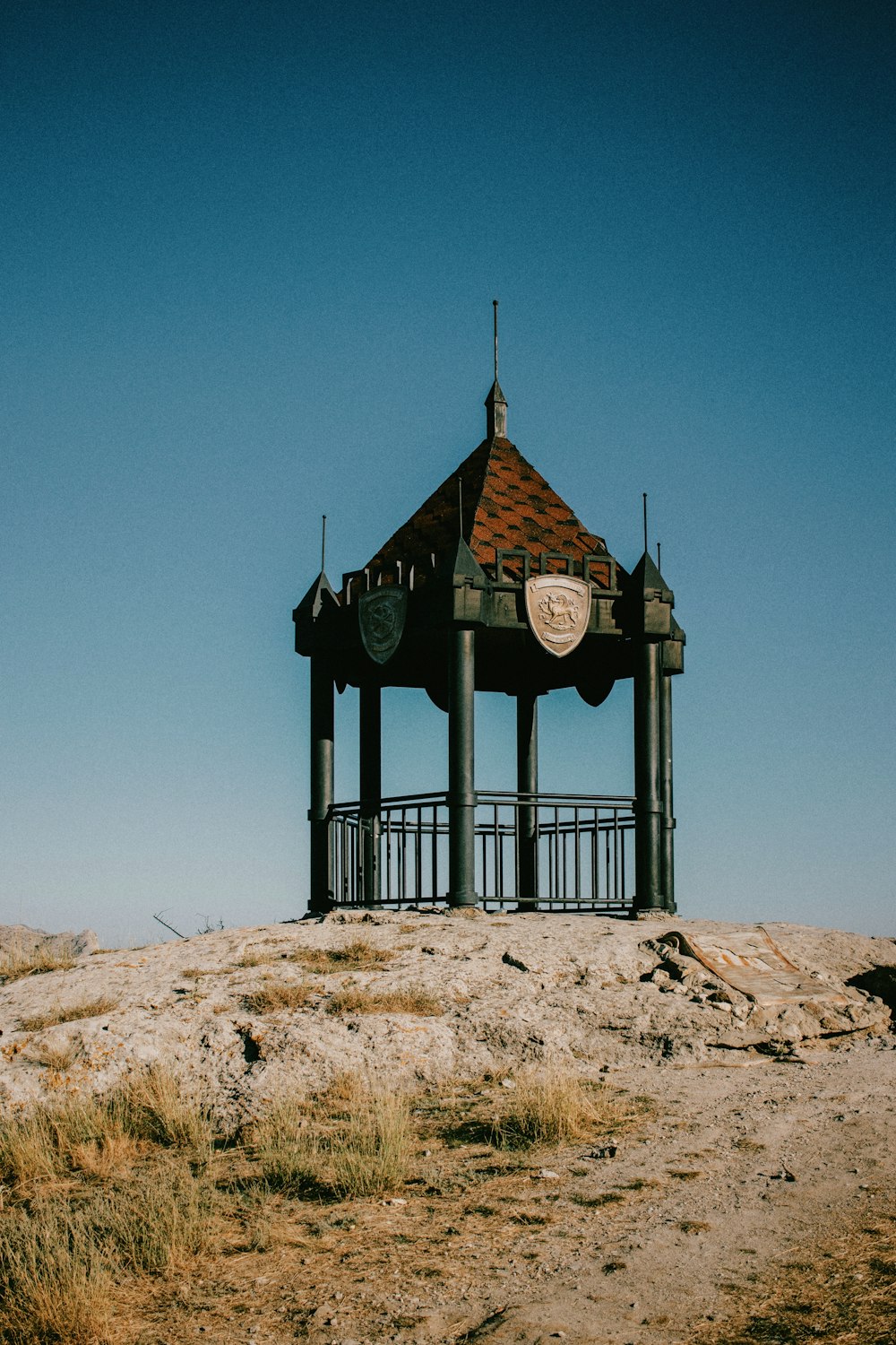 a clock tower sitting on top of a sandy hill