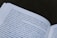 A close-up view of an open book with text in Italian. The pages are slightly curved, and the focus is on the text, making some words clear while others are slightly out of focus.