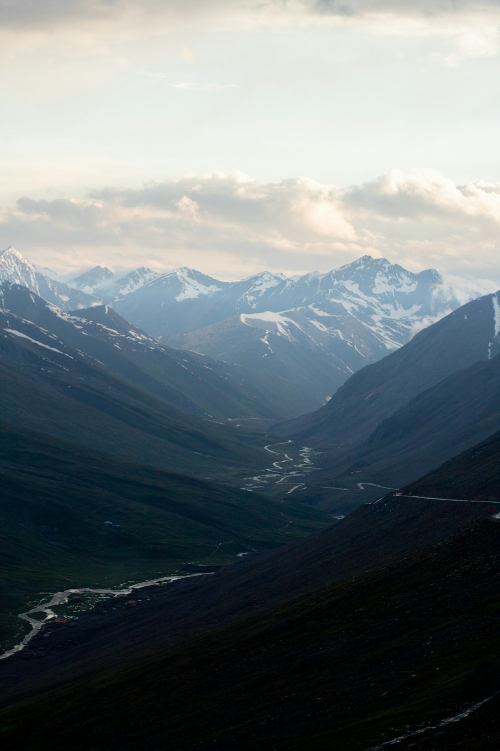 a view of a valley with mountains in the background