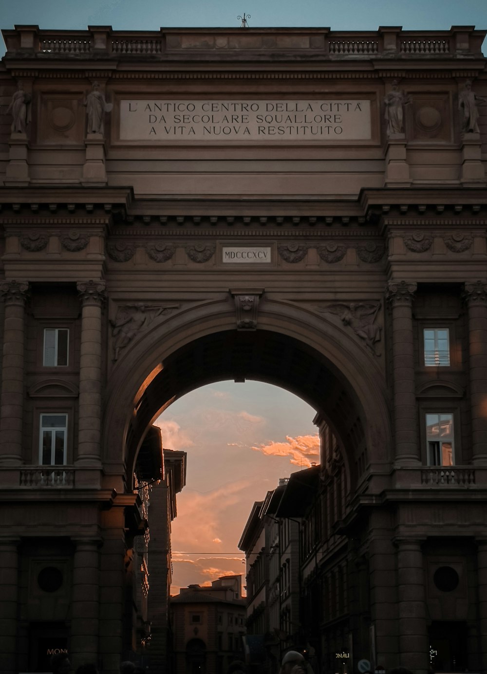 a very tall arch with a sky in the background