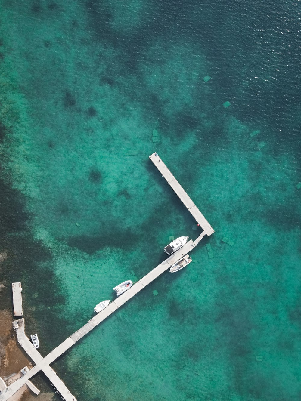 an aerial view of a dock in the water