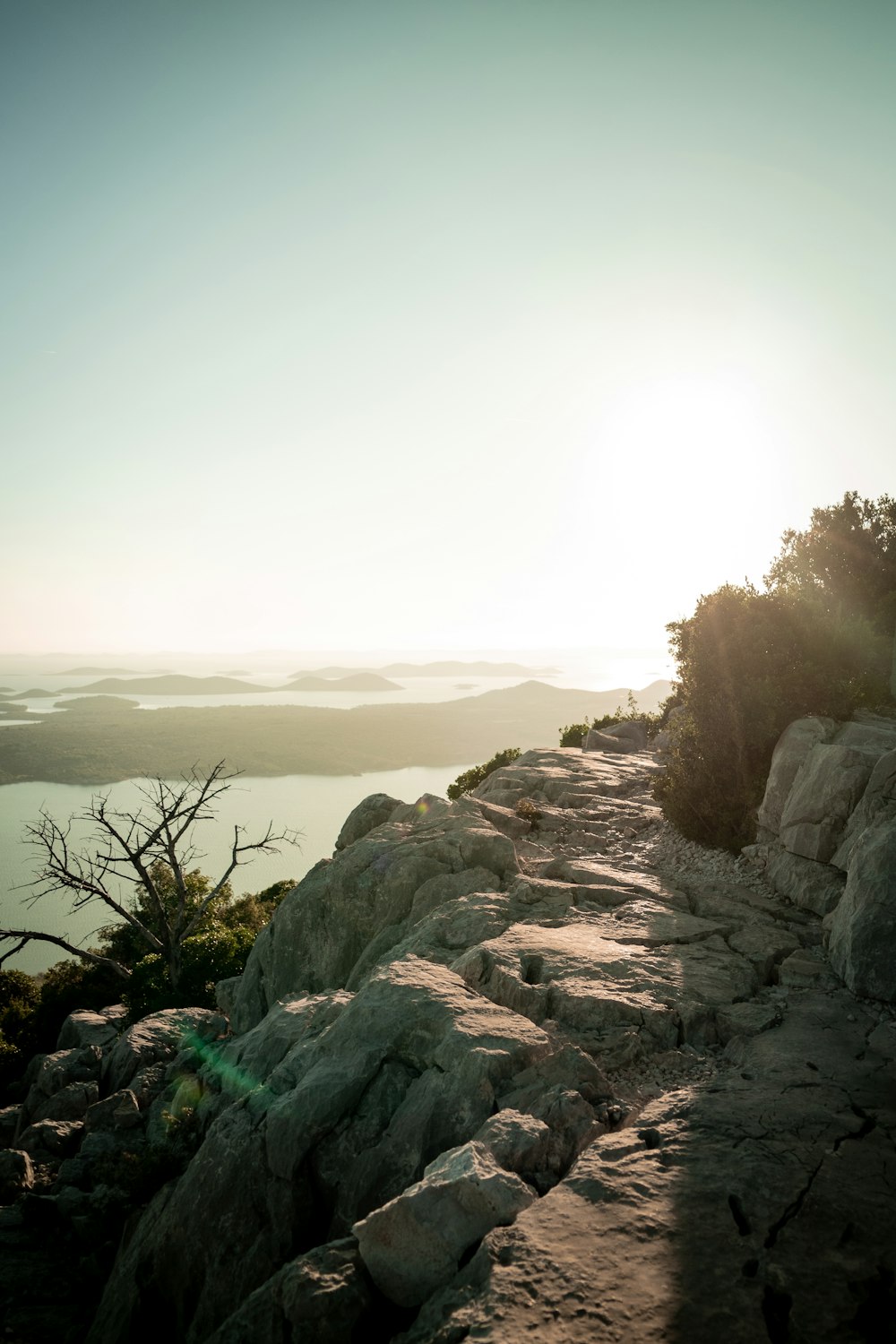 the sun is shining on a rocky path