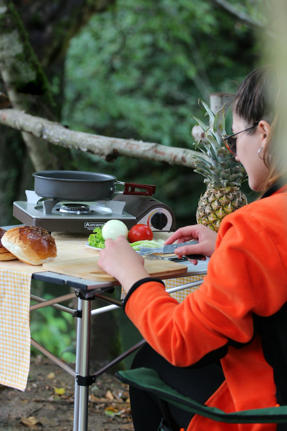 a woman sitting at a table with a plate of food