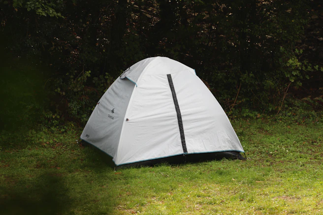 a white tent sitting on top of a lush green field