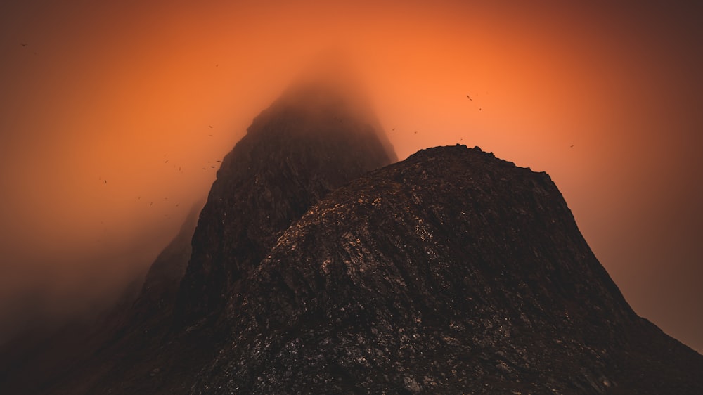 a very tall mountain with a foggy sky behind it