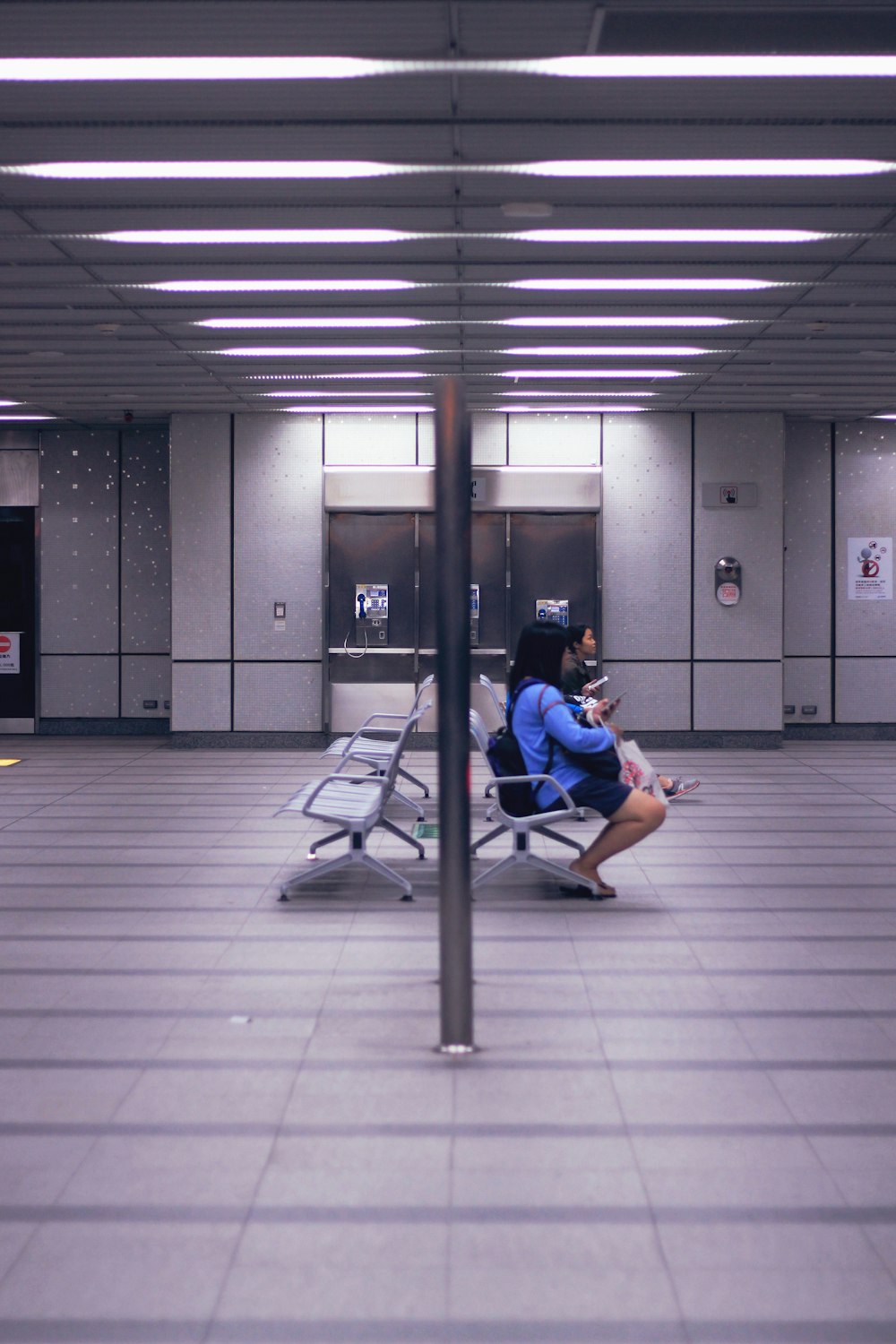 a person sitting on a bench in a building