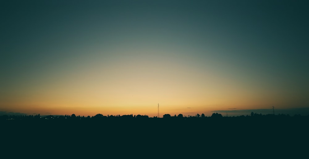 the sun is setting over a city skyline