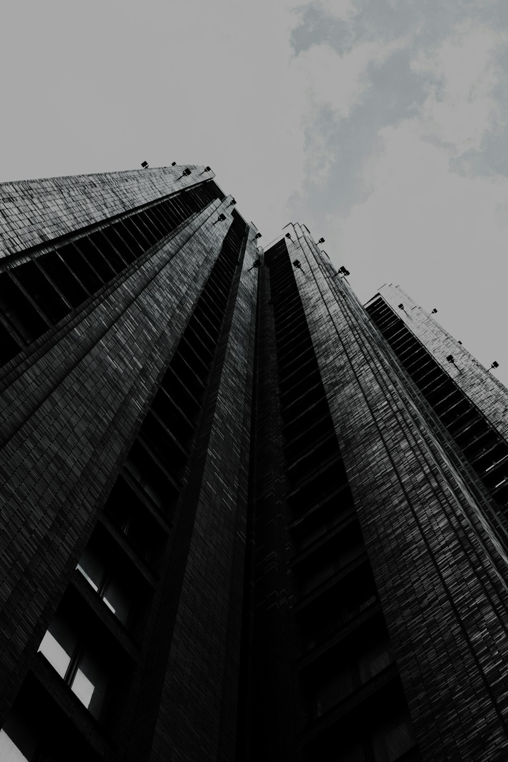 a black and white photo of tall buildings