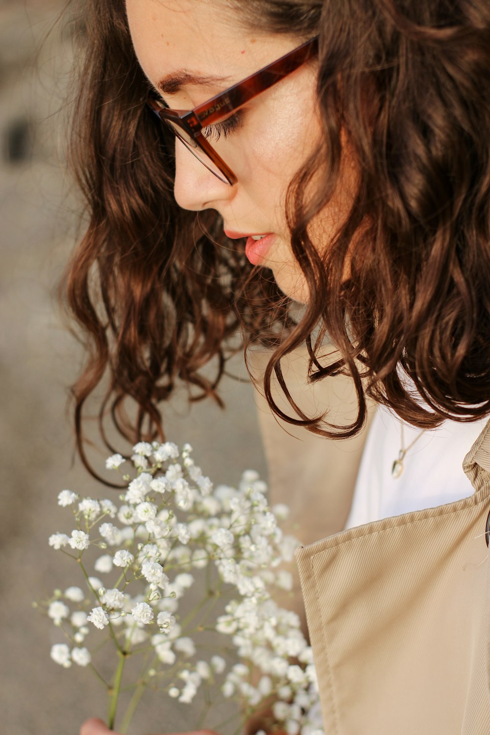 a woman holding a bouquet of white flowers